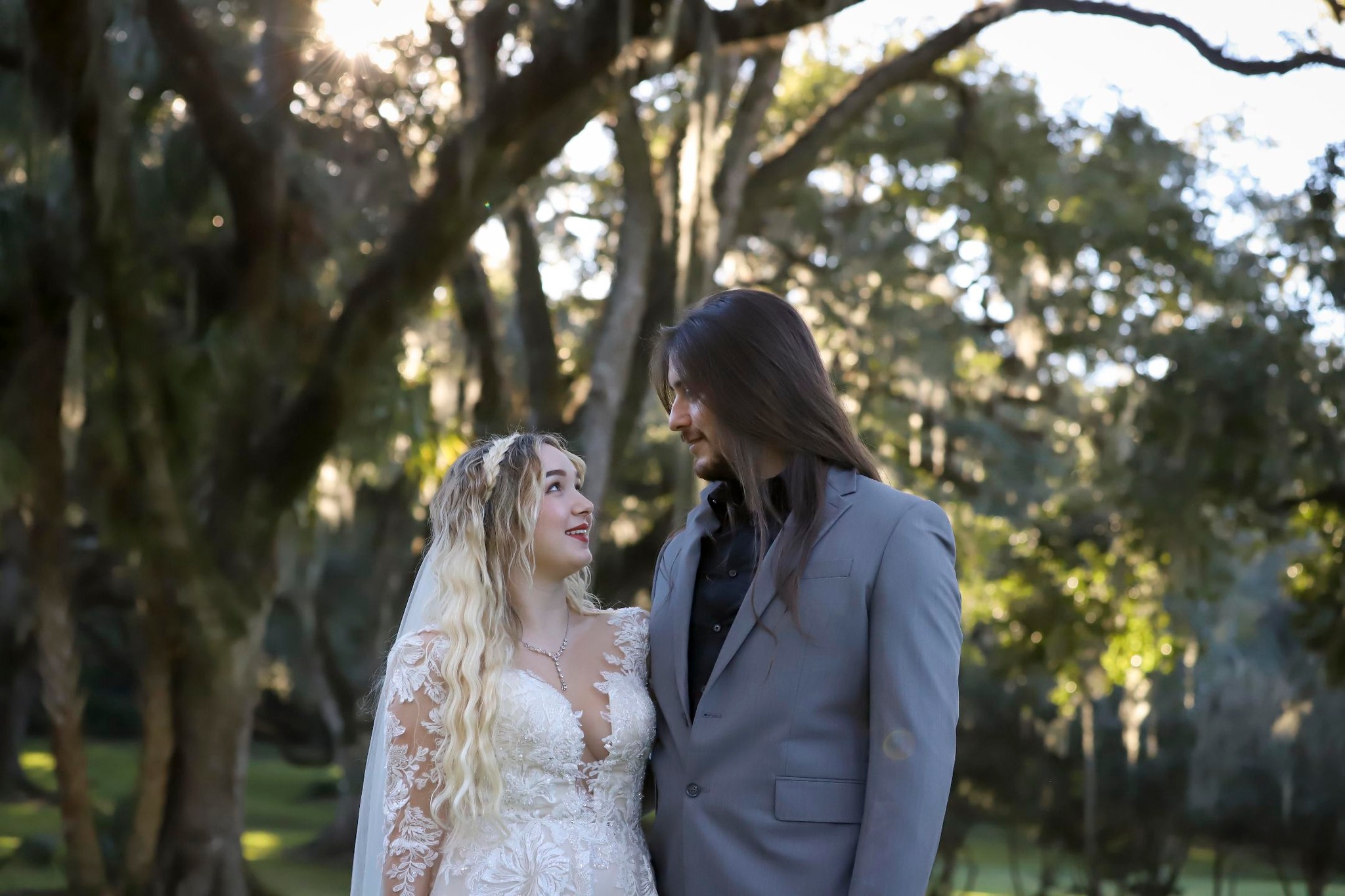 Bride and groom beneath moss-draped oak trees at golden hour — engagement photography across Acadiana by AG Photography